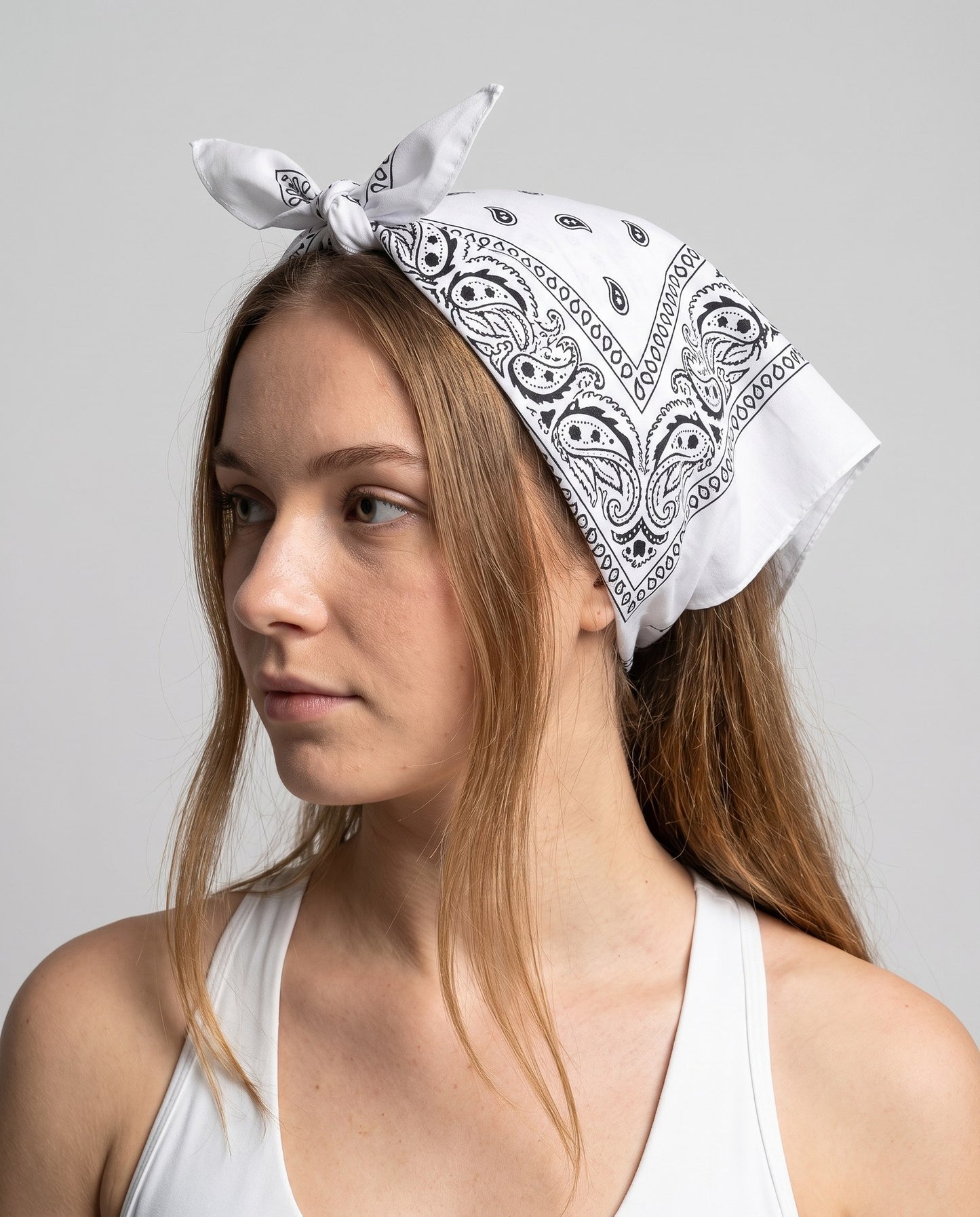 Bandana paisley bianca annodata sopra la testa, stile foulard